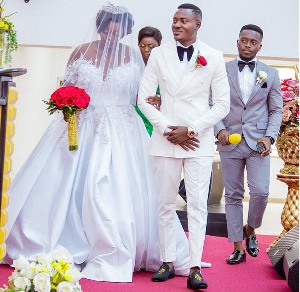 Henry Gyan walk down the aisle with his wife