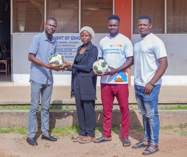 Mashood Djabeng (left) receiving the footballs on behalf of the department