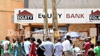People line up to withdraw money at an Equity Bank ATM at Kabalagala