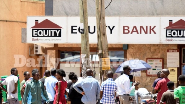 People line up to withdraw money at an Equity Bank ATM at Kabalagala