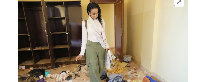 Sudanese journalist, Shamael Elnoor, inspects her room at home after it was destroyed