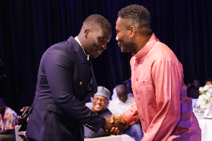 A photo of Asamoah Gyan and CEO of Kick Nation Sports Agency, Wunnam Haruna