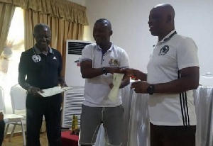 Winfred Dormon receiving his certificate after the course