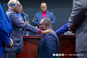 Dr. Bryan Acheampong being prayed for during his visit