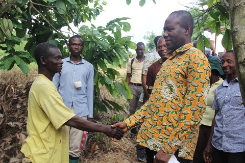 Joseph Boahen Aidoo exchanging pleasantries with a farmer
