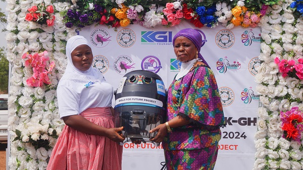One of the beneficiaries receiving items to aid in what she has learnt
