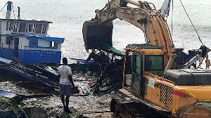Fishing vessel been dugged out by an excavator at the Elmina fishing harbour