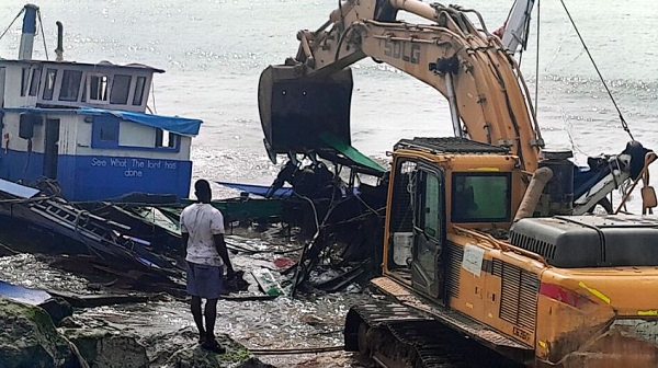 Fishing vessel been dugged out by an excavator at the Elmina fishing harbour