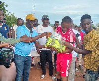 Dr Bandim handing over some sports kits to one of the players