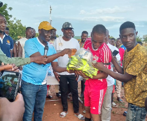 Dr Bandim handing over some sports kits to one of the players