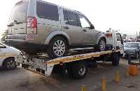 The broken down vehicle being towed away for maintenance