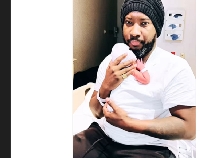 Sonnie Badu with his new baby