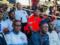 Black Stars assistant coach, John Paintsil [in Red] watching a GPL match