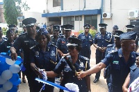COP Rose Atinga Bio being assisted by the IGP to cut the tape