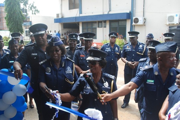 COP Rose Atinga Bio being assisted by the IGP to cut the tape