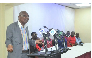 Quansah speaking at the briefing