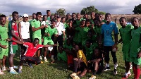 Head coach of Bechem United, Erol Bekir with his players