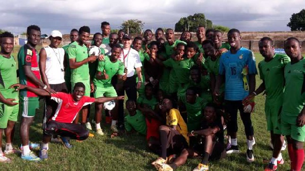 Head coach of Bechem United, Erol Bekir with his players