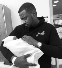 John Dumelo with his newly born baby