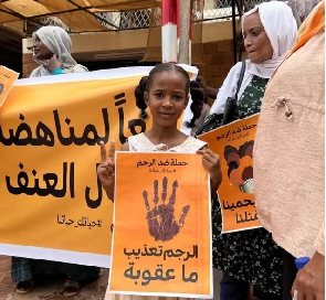 Protesters for Khartoum wit posters say
