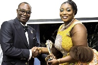 Dr. Brown Osei Konada(L) receiving Pan African Top  Brands Eminence Awards from Prof. Gifty Akushika