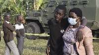 Dem dey hold and comfort one boy for di scene of di attack for Mpondwe, Uganda on 17 June 2023