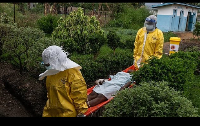 Medical staff carry an Ebola patient to a treatment center in Rwampara, Congo, Thursday, May 21, 202