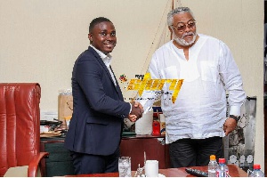 CEO of My Story Magazine, Nana Akwasi Bonsu in a handshake with JJ Rawlings