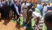 Daniel Mckorley cuts sod for the construction of the turf