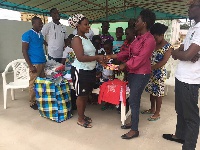 NLF presenting the cloths to one of the stewards at the home