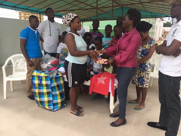 NLF presenting the cloths to one of the stewards at the home