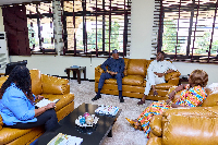 Baba Sadiq (in blue) meeting staff at the Ghana High Commission in Nigeria