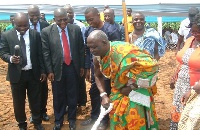 Nii Tetteh Otu cuts the sod, as officials of Chase Petroleum look on with excitement