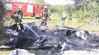 Firefighters extinguish fire during the mock plane crash drill at the Kahama airport in Tanzania