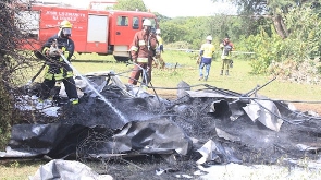 Firefighters extinguish fire during the mock plane crash drill at the Kahama airport in Tanzania