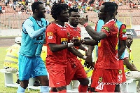 Yacouba is flanked by his teammates as he celebrates his second goal