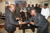 Akufo-Addo (left) in a handshake with Kenpong