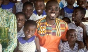 P.Y Addo Boateng, TV Host ad Philanthropist poses with the students