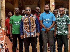 Dr Bampoe In A Pose With Staff At The Office