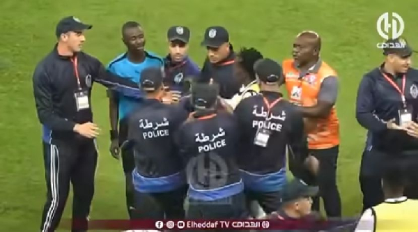 Charles Benle Bulu  (in blue) had to be escorted by security