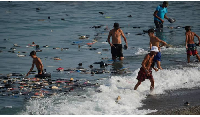 Belongings left behind by migrants float in the sea after they crossed from Morocco into the Spain