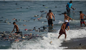 Belongings left behind by migrants float in the sea after they crossed from Morocco into the Spain