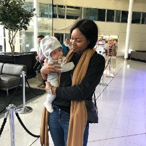 Yvonne Nelson poses with baby Ryn abroad