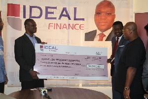 Staff of Ideal Financial Holdings presenting the cheque to Korle Bu
