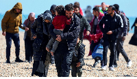 People believed to be migrants walk in Dungeness, Britain on August 16, 2023