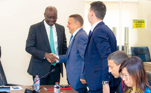 Minister of Finance, Dr Cassiel Ato Forson in a handshake with head of IMF Mission Ruben Atoyan