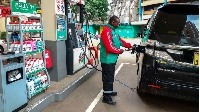 Pump attendant at the Rubis Petroleum Station  in Nairobi County, Kenya serving Pump attendant at th