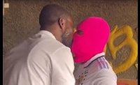 Isaac Kwame kissing an unknown lady during the kiss-a-thon attempt