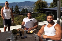 Anthony Joshua (M) with his coach and friend