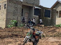 Suspected land guards hanging around an ongoing building project